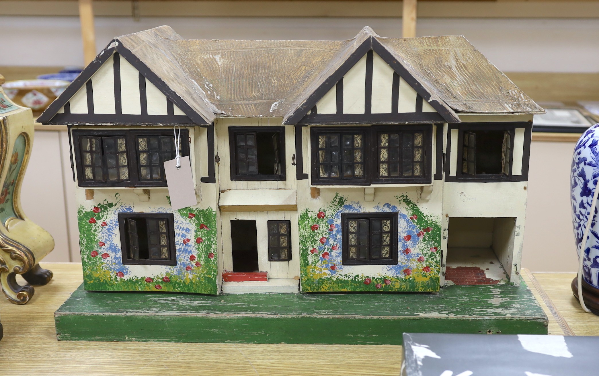 A Tri-Ang mock Tudor style doll's house and furnishings, 68cms wide, 42cms high